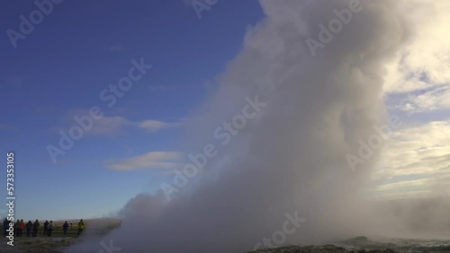 Strokkur geyser in southwestern Iceland. Erupting fountain-type geyser in Haukadalur valley on the slopes of Laugarfjall hill, which is also the home to Geysir geyser. photo