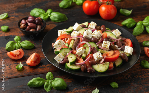 Greek salad with fresh vegetables, feta cheese, kalamata olives, dried oregano, red wine vinegar and olive oil. Healthy food.
