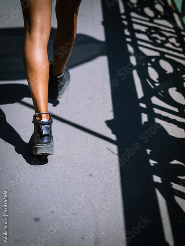 Young black hispanic woman walking cropped legs only
