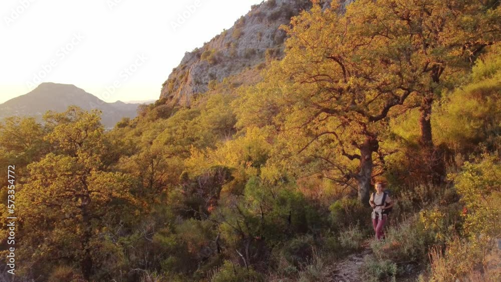 Drone video of young woman hiking on mountains in Europe. Beautiful autumn mountain nature in Montenegro at sunset. Female backpacker coming down from the mountains after a long walk in nature Drone video of young woman hiking on mountains in Europe. Beautiful autumn mountain nature in Montenegro at sunset. Female backpacker coming down from the mountains after a long walk in nature