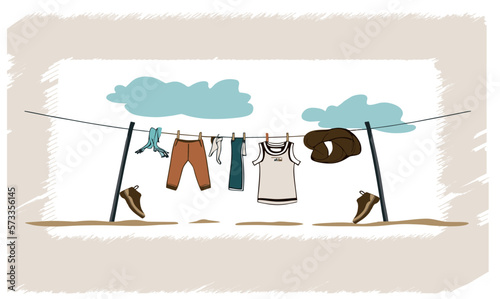 clothes are drying in the wind, there are shoes nearby