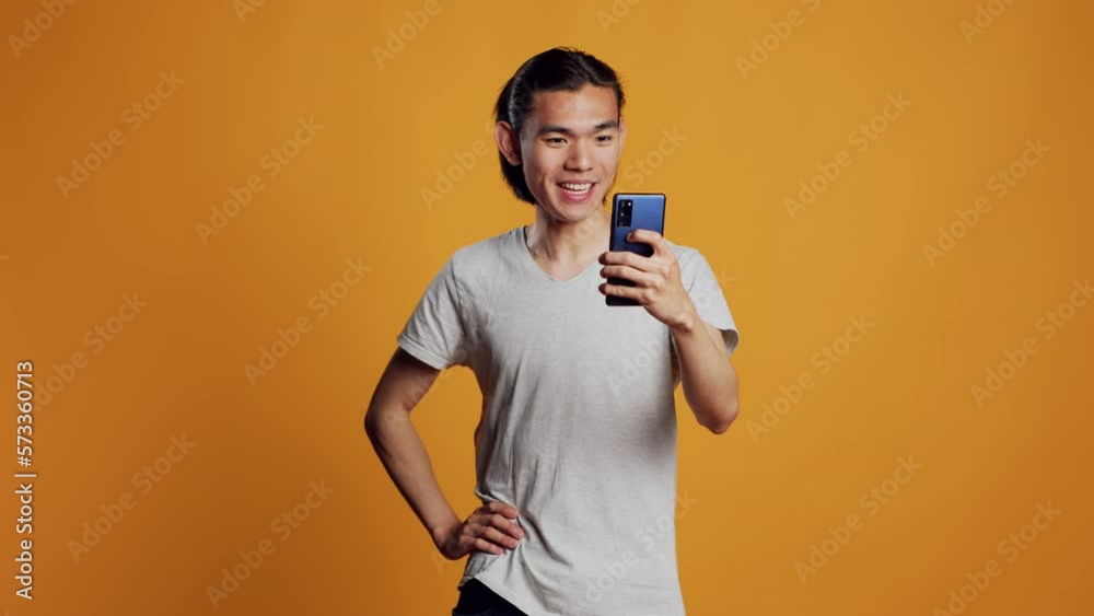Positive friendly guy talking on videocall meeting, using online teleconference call for remote conversation on camera. Young modern man using smartphone to chat on videoconference, internet.
