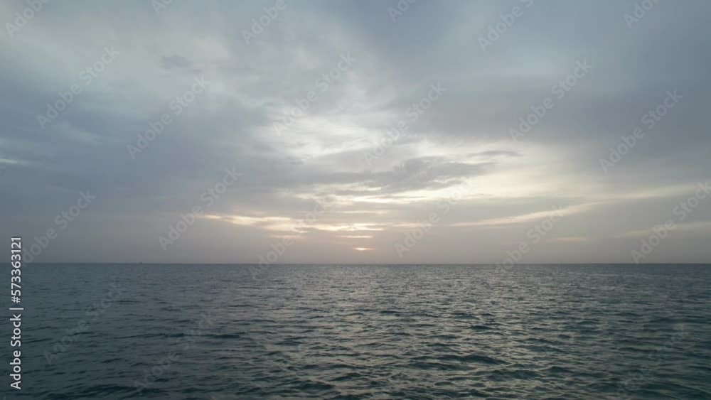 View of the clouds over the sea at sunrise. Blues mix with oranges, golden hour. View of the clouds over the sea at sunrise. Blues mix with oranges, golden hour.