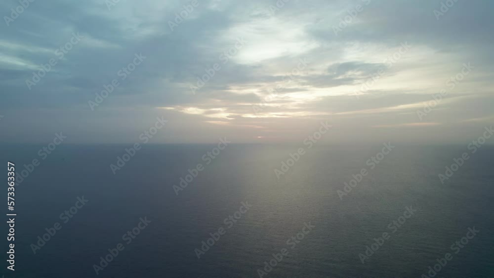 View of the clouds over the sea at sunrise. Blues mix with oranges, golden hour. View of the clouds over the sea at sunrise. Blues mix with oranges, golden hour.