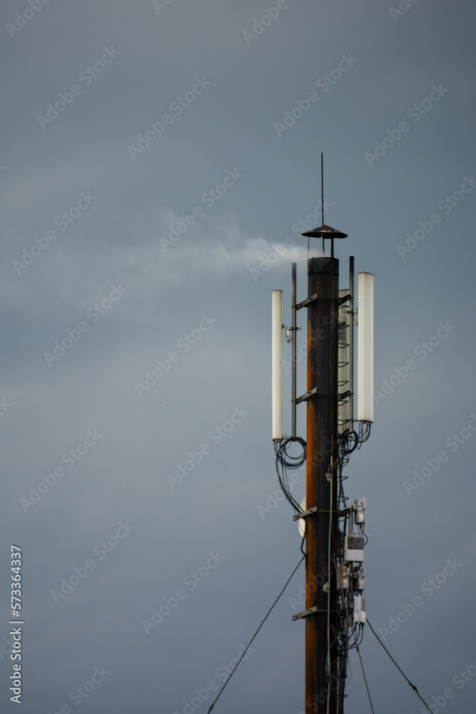 Obraz premium smoking chimney with telecommunications