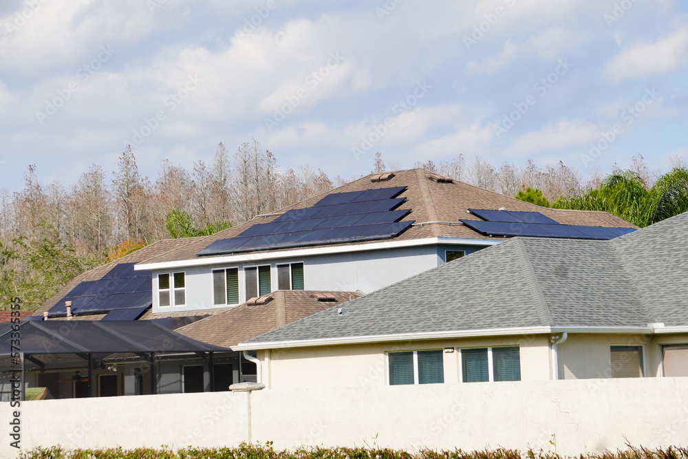 Fototapeta premium Solar panel on a house roof; Green energy from sun