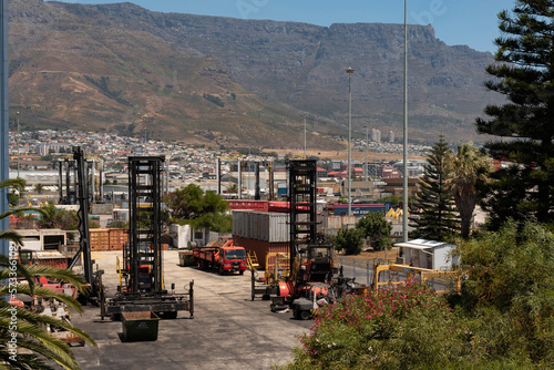 Cape Town South Africa. 2023. Forklift vehicles used in the container terminal. Backdrop is Table Mountain.