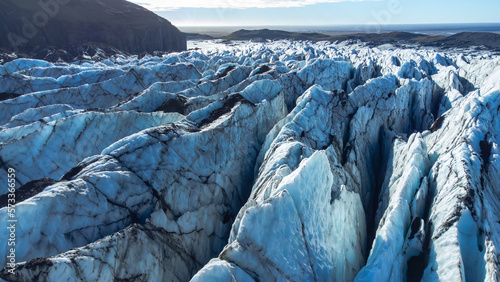 Huge glacier with pure blue ice at sunny weather. Vatnajokull glacier in Iceland. Beautiful nature abstract background. Ice texture landscape aerial view.