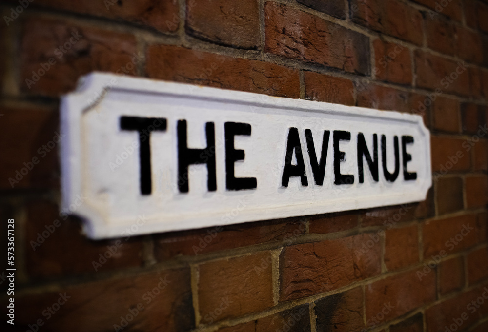 Fototapeta premium Street name called The Avenue on a red brick wall