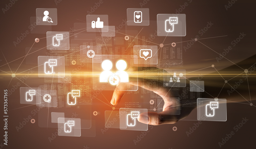 Hand pressing social media multimedia application screen with media icons on futuristic concept Hand pressing social media multimedia application screen with media icons on futuristic concept