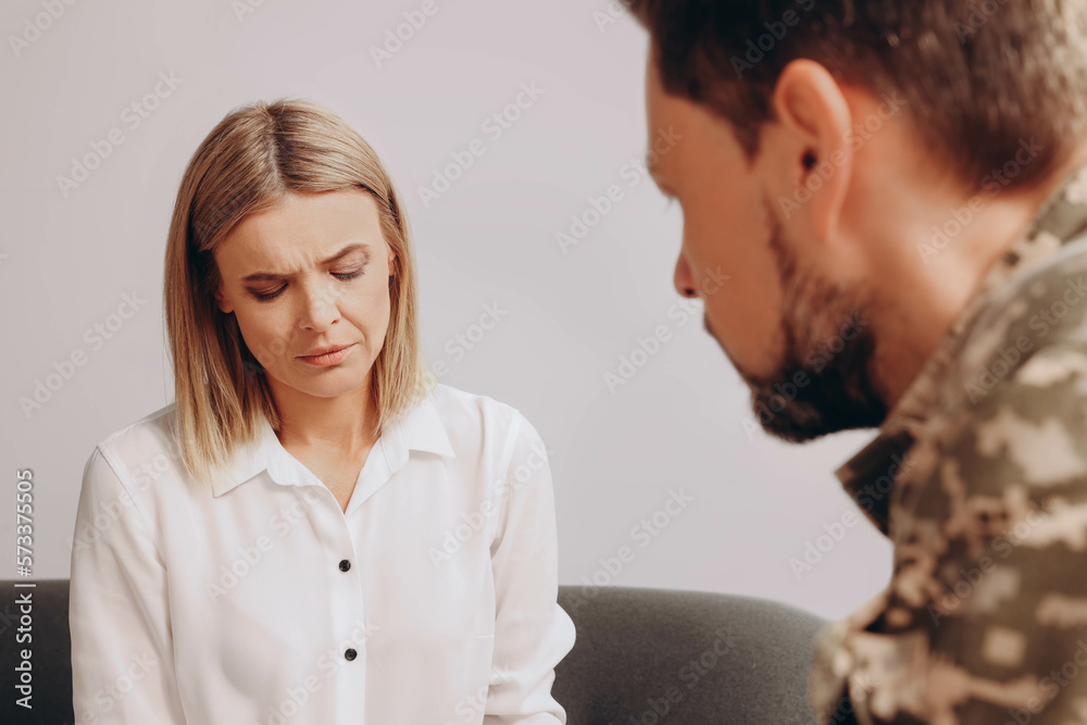 Psychologist working with military officer in office Psychologist working with military officer in office