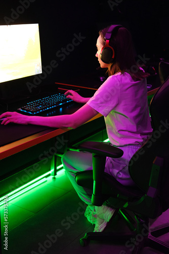 Gamer young girl plays online
