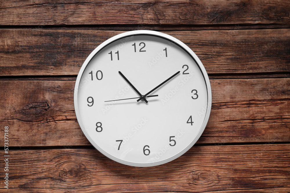 Stylish round clock on wooden table, top view. Interior element Stylish round clock on wooden table, top view. Interior element
