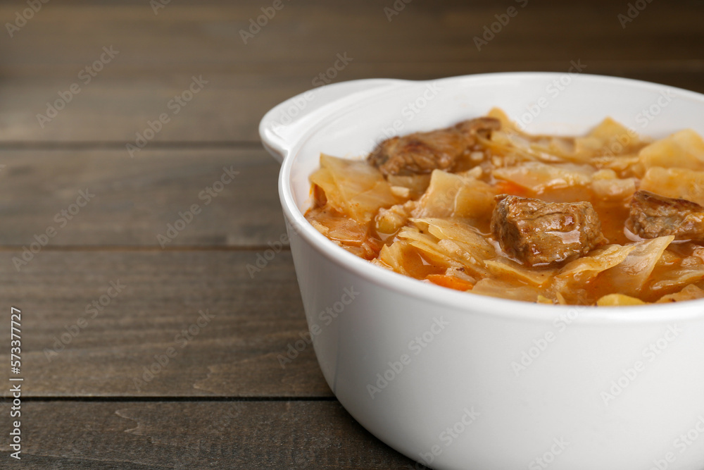Tasty cabbage soup with meat and carrot on wooden table, closeup. Space for text Tasty cabbage soup with meat and carrot on wooden table, closeup. Space for text