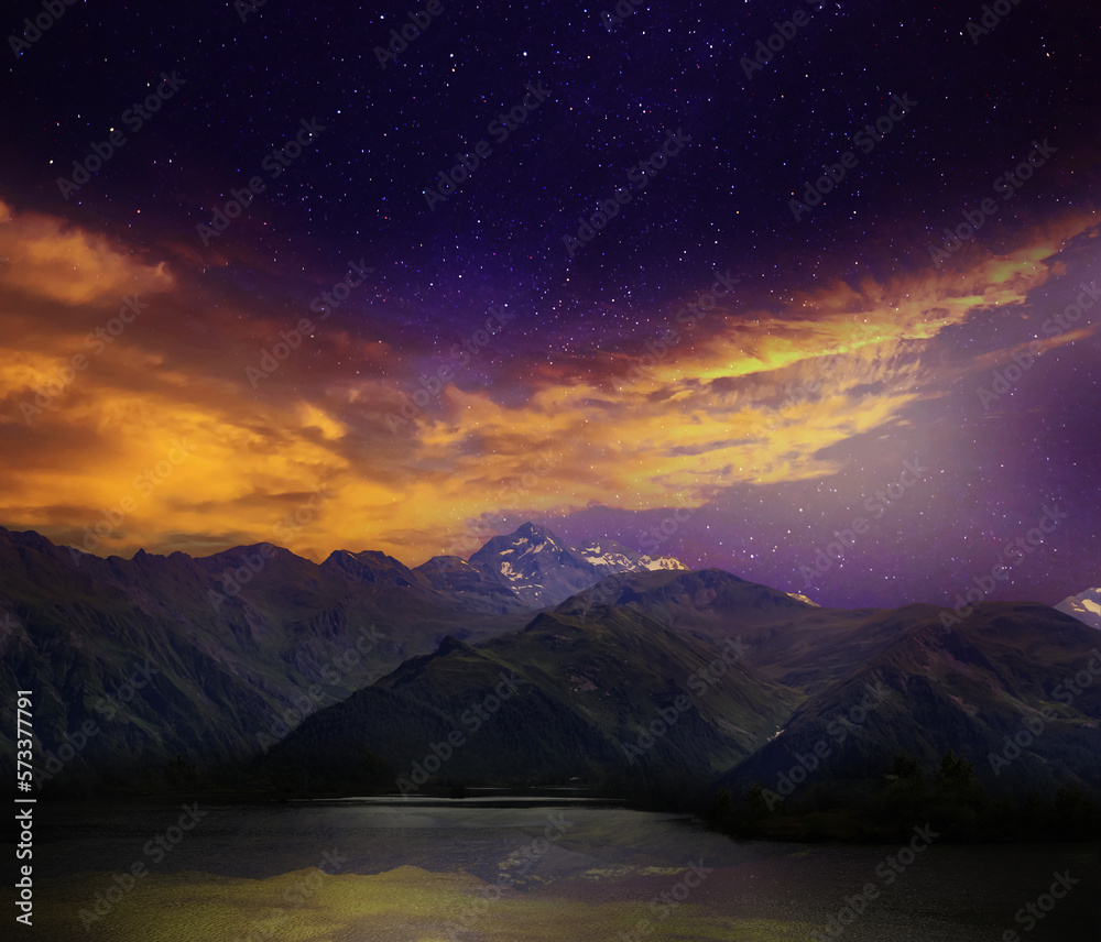 Fantastic sky with many stars and beautiful clouds over mountains