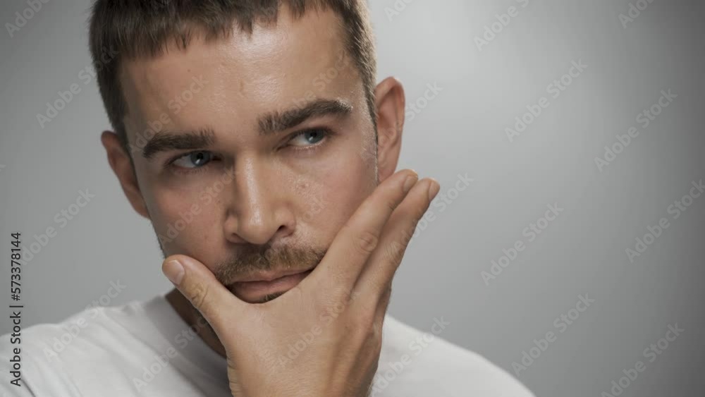 Handsome bearded man with clean skin against gray background Handsome bearded man with clean skin against gray background