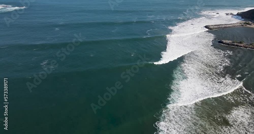 Punta Galera Jetty Wave Peeling off the Breakwater. Drone pans to starting to cliff side.  Big Perfect Waves next to the Village photo