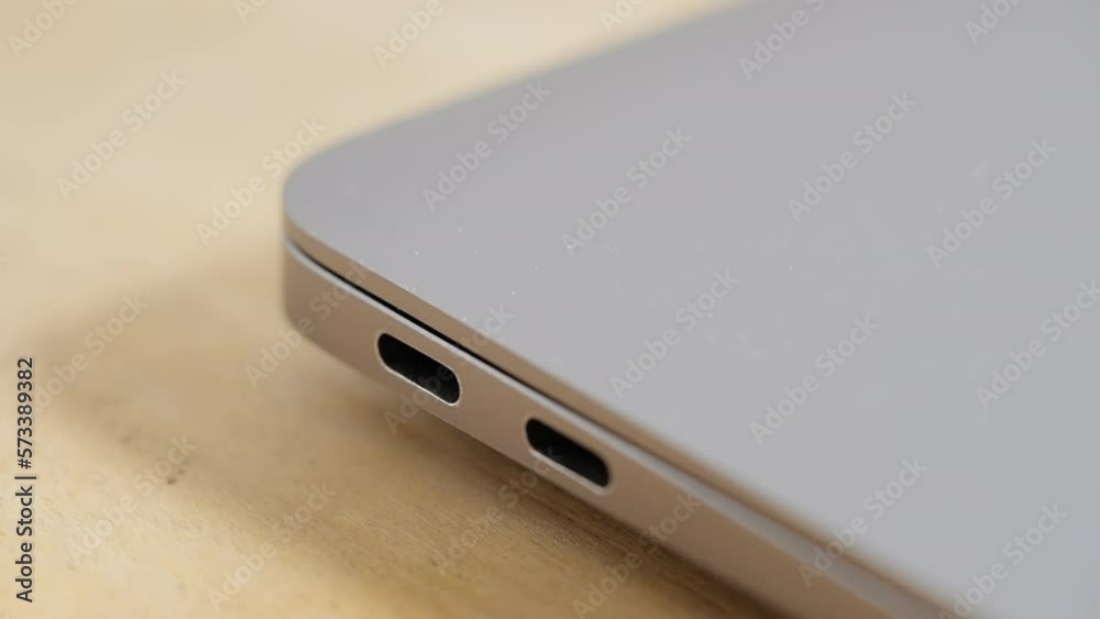Unplugging usb-c cable from laptop, close up Unplugging usb-c cable from laptop, close up