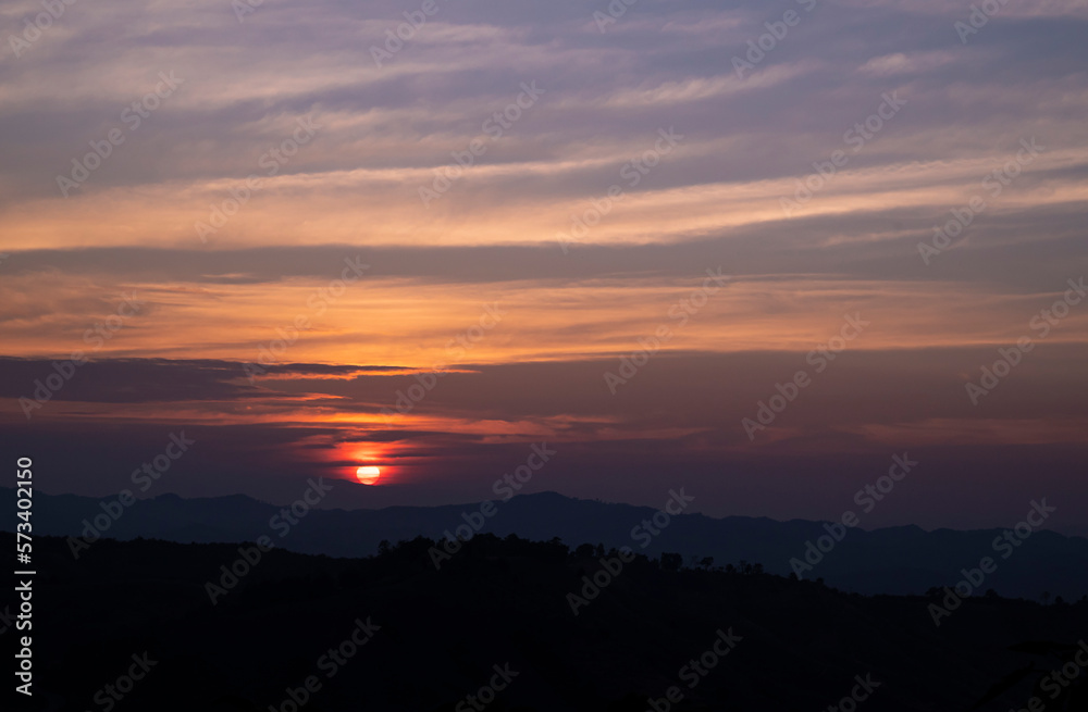 Natural backgrounds of the sunset view with the evening sky on the mountain in the winter of Nan province, The north of Thailand.