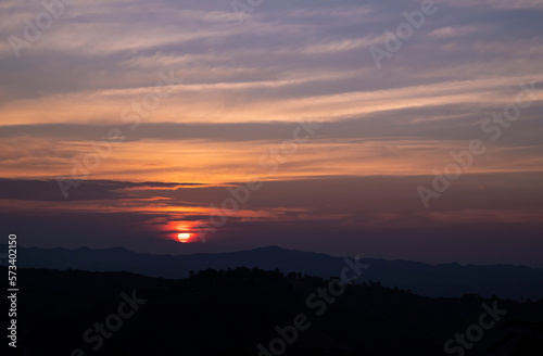 Natural backgrounds of the sunset view with the evening sky on the mountain in the winter of Nan province, The north of Thailand.
