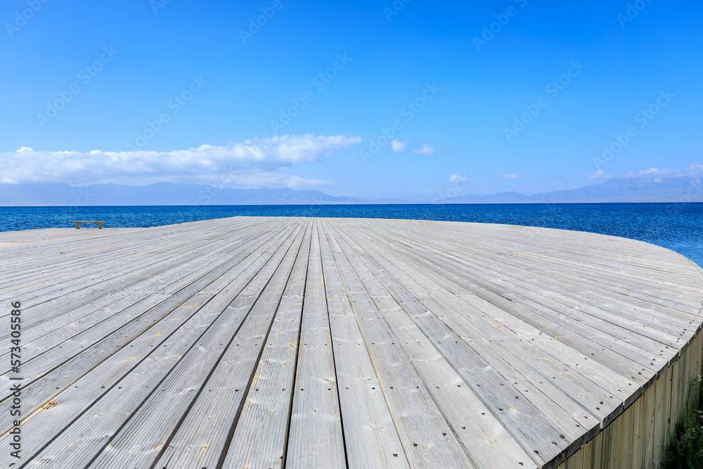 Empty wooden square with clear lake natural background in Xinjiang, China.