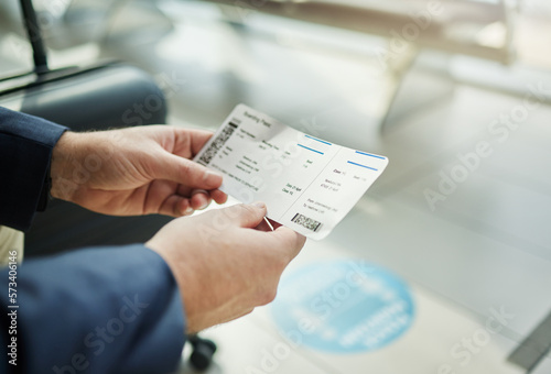 Plane ticket in hands, travel and person at airport, waiting on flight for business trip, check in and boarding. Closeup, .professional conference or convention with travelling for work and journey photo