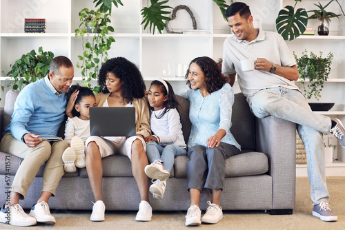 Big family, home and laptop on couch learning with online education, games or movie. Parents, grandparents and children relax together in lounge with internet for quality time streaming and bonding