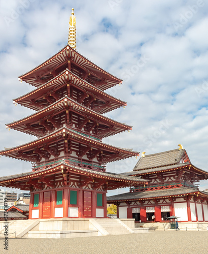 Red and gold colorful temple traditional architecture building and pagoda at the Shi-Tennoji Buddhist Temple in Osaka Japan