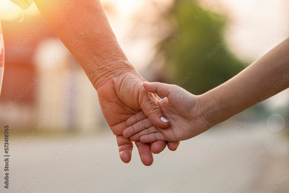 parent holds the hand of a small child parent holds the hand of a small child