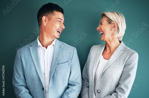 Mockup, business people and laughing team in studio for fun and happy conversation or comedy on green background.Partnership and man with senior woman with humor, joke or discussion while isolated