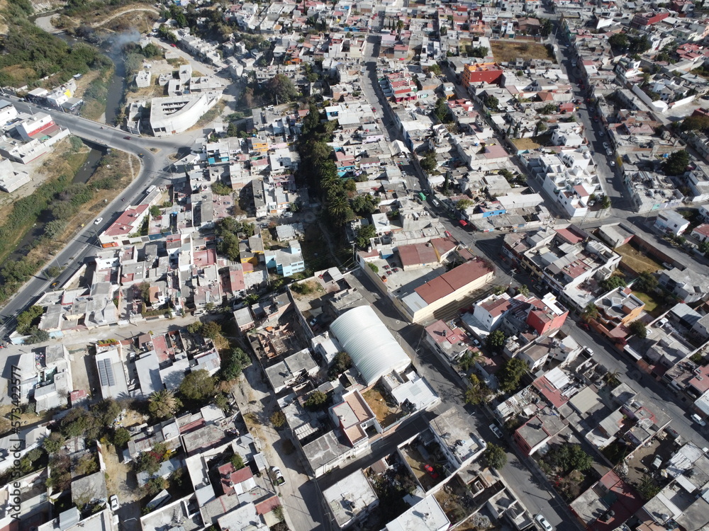 a drone photo aerial view of the city in puebla, mexico, hispanic downtown with the blue sky, clouds and travel 
