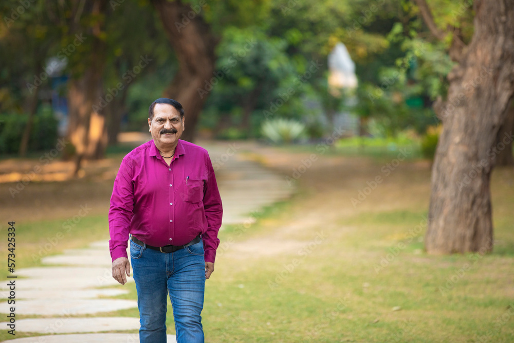 Senior Indian man in formal wear at park. Senior Indian man in formal wear at park.