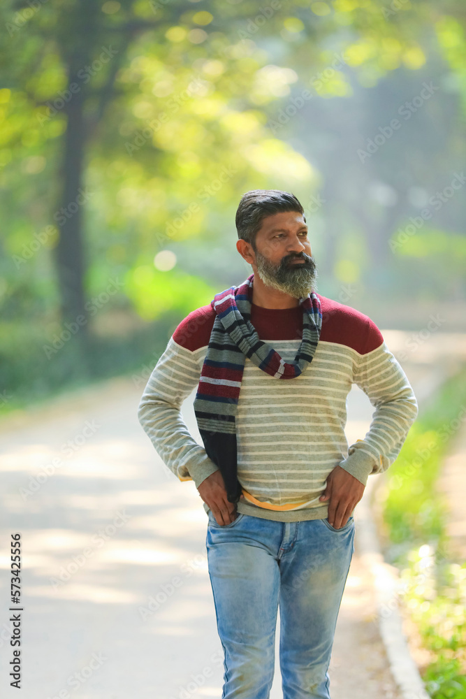 Indian man walking and giving expression at park. Indian man walking and giving expression at park.