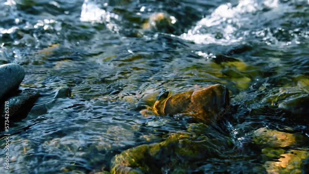 Motorised dolly slider shot of the splashing water in a small mountain