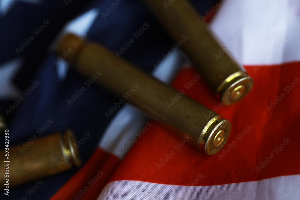 Obraz premium Many bullets cartridges and medals on United States flag. Concept of war glory victory. Gun trafficking on special operations