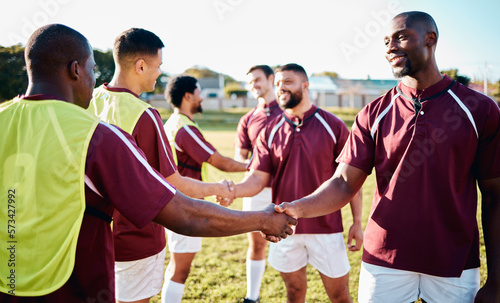 Man, sports and handshake for team greeting, introduction or sportsmanship on the grass field outdoors. Sport men shaking hands before match or game for competition, training or workout exercise photo