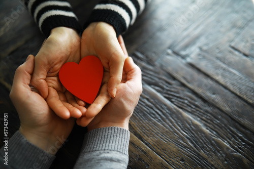 Hands of a woman holding and offering a heart shape. Love  health concept. Selective focus.Cinematic effect.