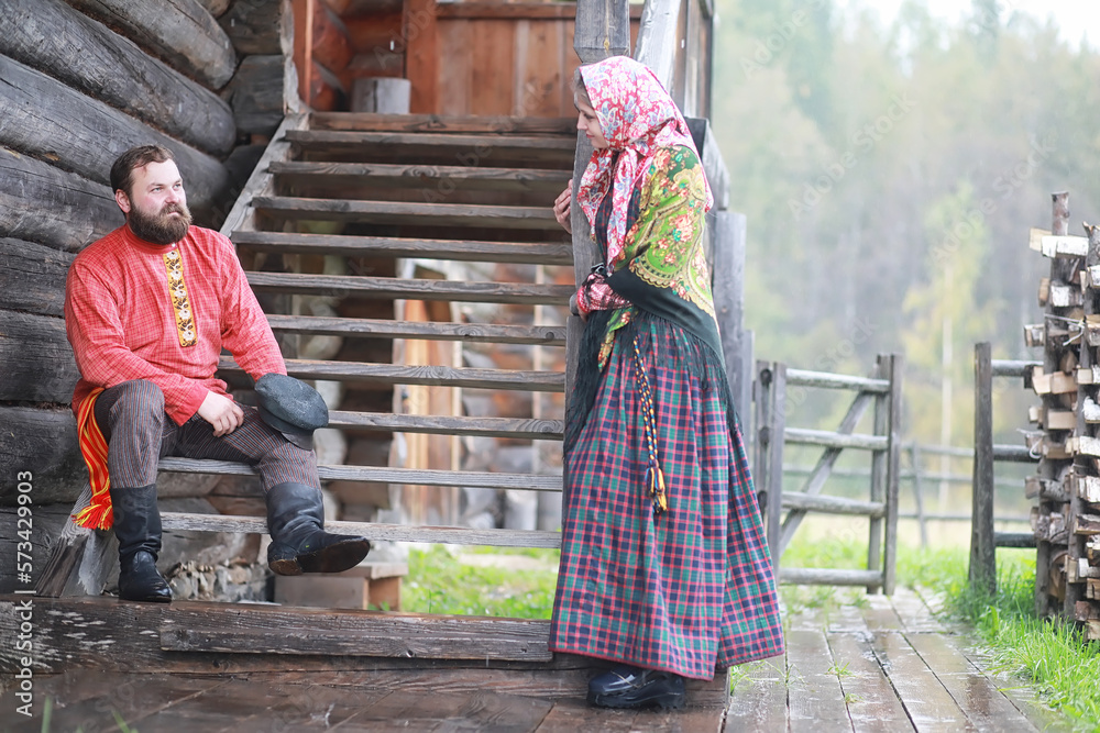 Traditional Slavic rituals in the rustic style. Outdoor in summer. Slavic village farm. Peasants in elegant robes. Traditional Slavic rituals in the rustic style. Outdoor in summer. Slavic village farm. Peasants in elegant robes.