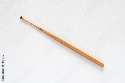 Handmade bamboo ear wax remover on white background.