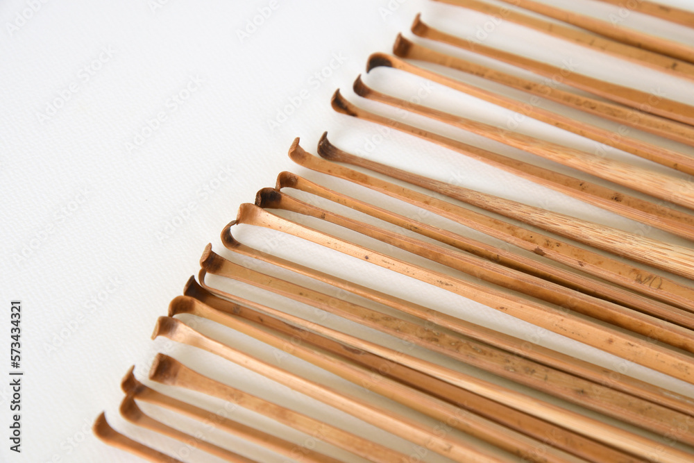 Handmade bamboo ear wax removers on white background.