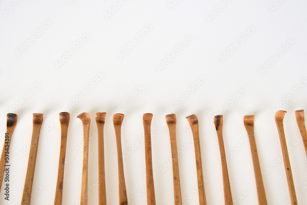 Handmade bamboo ear wax removers on white background. Handmade bamboo ear wax removers on white background.