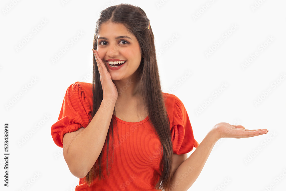 Portrait of beautiful woman gesturing against white background