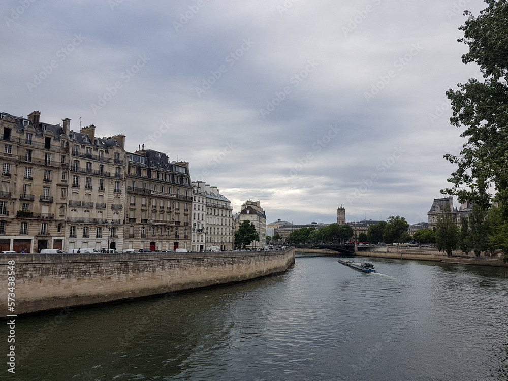 Barge at river Seine in Paris with buildings at Ile Saint-Louis