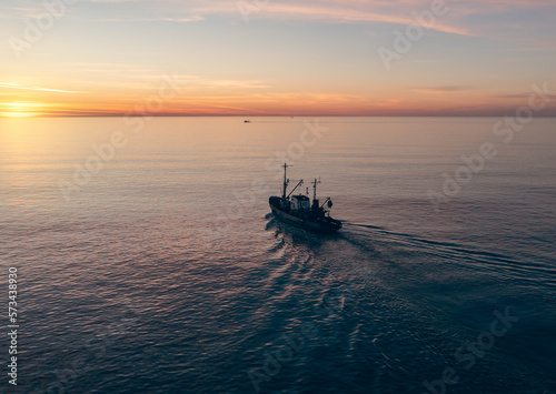 Small Fishing Boat catch fish, aerial Top View from drone. Industrial commercial fishing. © DedMityay