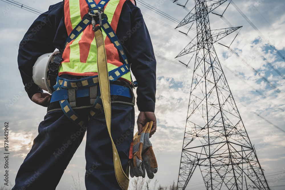 Asian electrical engineer wearing safety gear working high voltage ...