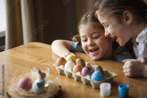 Photography happy children paint eggs for easter at home