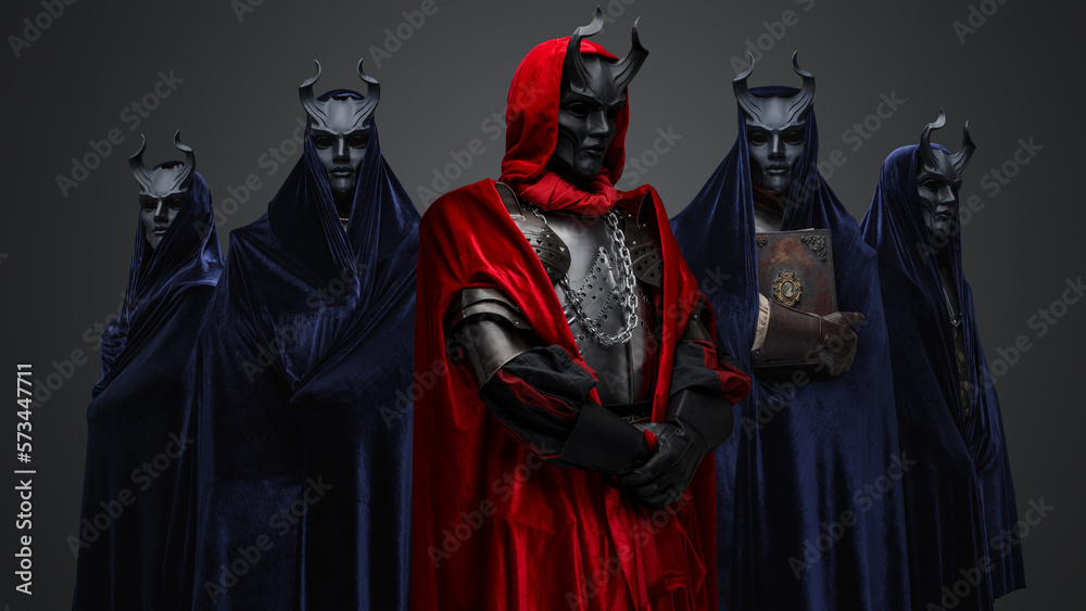 Studio shot of five members of occult brotherhood against gray background.