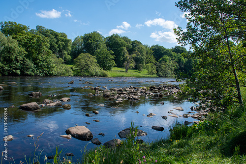 A sunny summer's day, with blue skies over River North Tyne at Chesters in Northumberland, UK photo