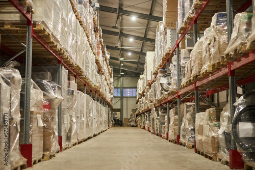 Background image of indoor warehouse interior with shelves stacked with cardboard boxes, copy space