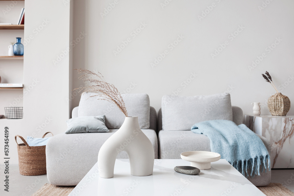 Obraz na płótnie View of modern scandinavian style interior with sofa and trendy vase, Home staging and minimalism concept w salonie